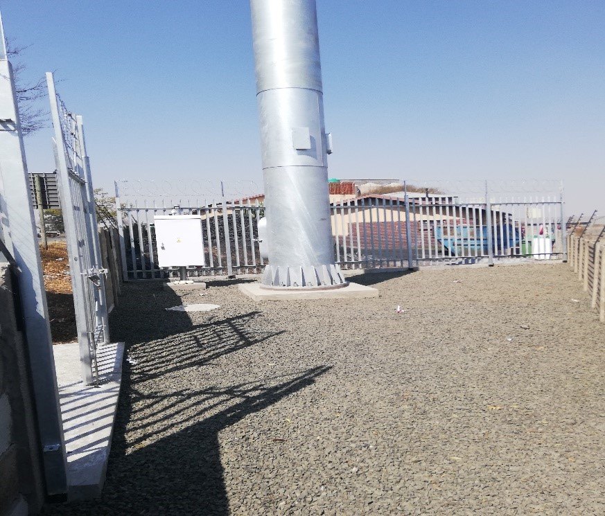 Base of a monopole tower inside a fenced compound